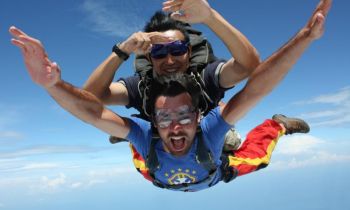 Two skydivers on a tandem jump over the city of Sydney