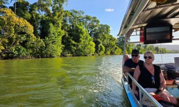 Two people on a river cruise on the daintree river