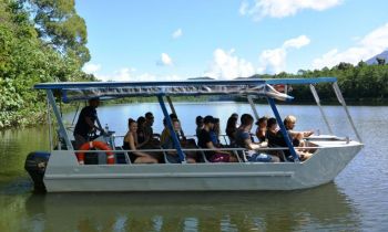 A small boat full of backpackers on a crocodile cruise on the daintree river with Uncle Brians