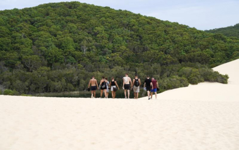 A group of backpackers having fun in the Eli Creek lazy river on K'Gari Fraser Island