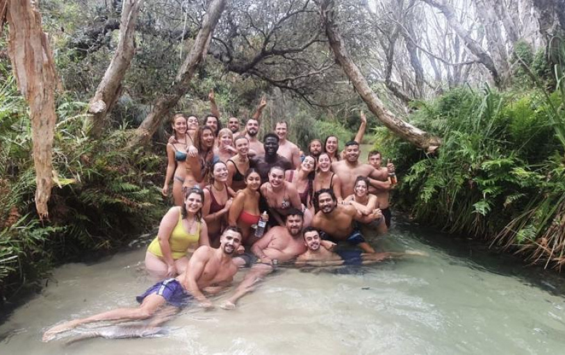 A group of backpackers having fun in the Eli Creek lazy river on K'Gari Fraser Island