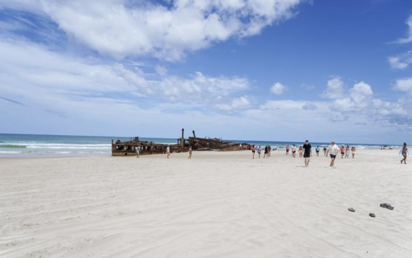 A group of backpackers having fun in the Eli Creek lazy river on K'Gari Fraser Island