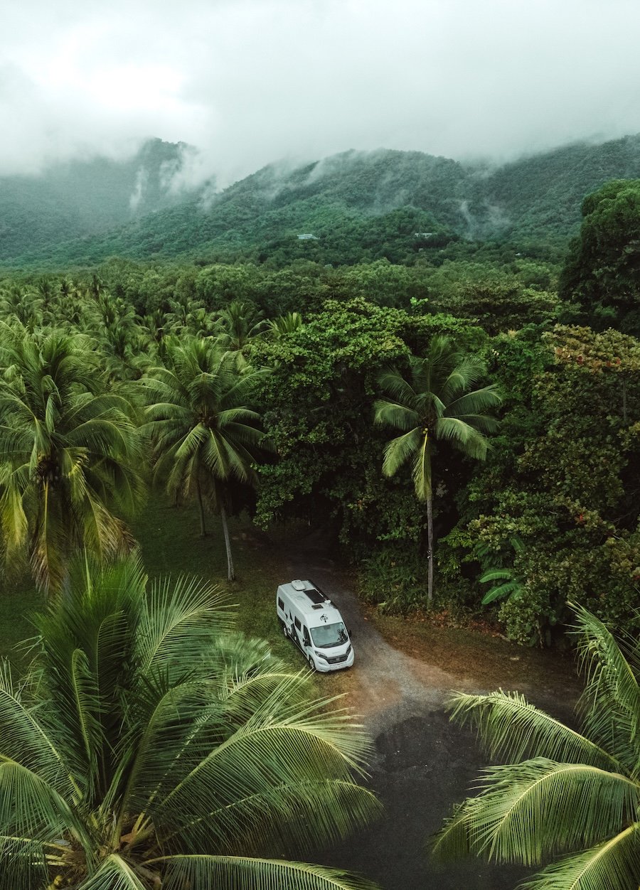 Campervan parked in a clearing in the daintree rainforest