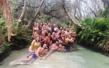 A group of backpackers having fun in Eli Creek on the island expeditions 3 day 2 night kgari trip