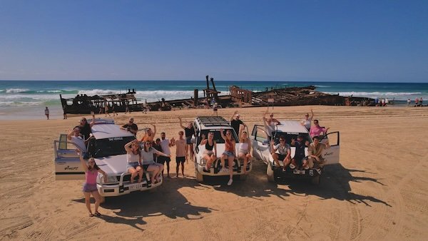 A group of friends having fun on K'gari during the 27 day East Coast Explorer