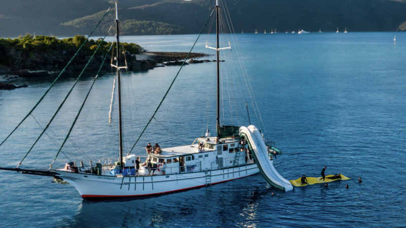 sailing vessel in the whitsundays with a silde off to the side