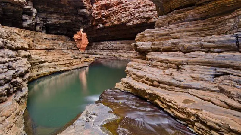 Stunning turquoise pool weaving through dramatic rugged rock formations on a 10 Day Broome to Perth West Coast Adventure tour.