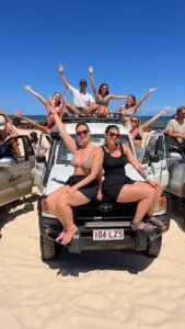 a group of friends having fun with on a 4wd on K'gari Fraser Island