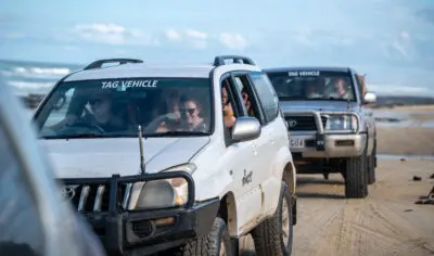 a group of friends having fun with on a 4wd on K'gari Fraser Island