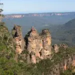 Iconic Three Sisters rock formation in Blue Mountains, seen on a 1-day guided wildlife park tour through lush forested mountains.