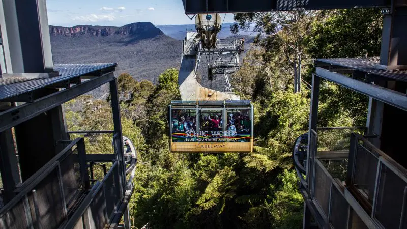 Experience a scenic cable car ride on a 1 Day Blue Mountains Tour, soaring high above lush valleys with breathtaking mountain views.
