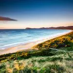 Scenic wooden stairs descend to Bruny Island’s iconic sandy isthmus, a must-see attraction on top-rated Tassie Tours Tasmania day trips.