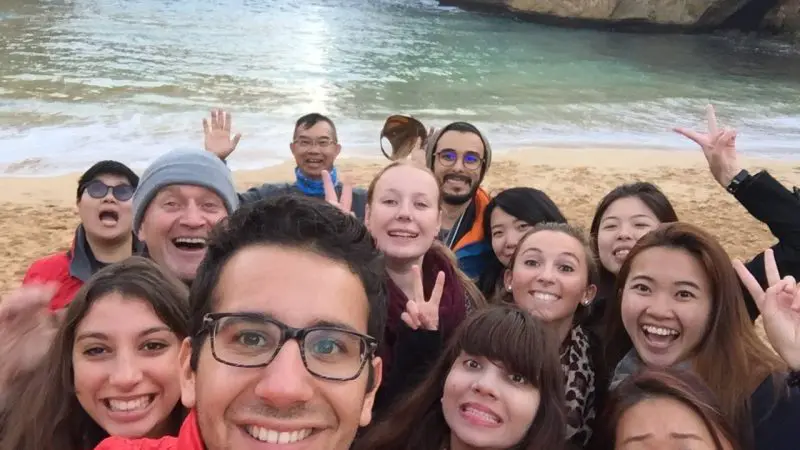 A happy group of friends snaps a selfie during their 1 Day Great Ocean Road and 12 Apostles Tour with Go West Tours in Australia.
