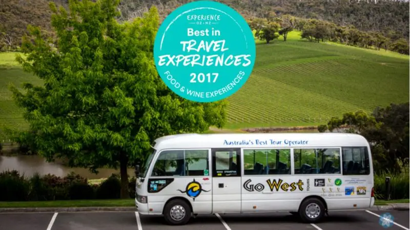 Go West Yarra Valley Grazing Tour white coach by scenic vineyards; Best in Travel Experiences 2017 award badge displayed above.