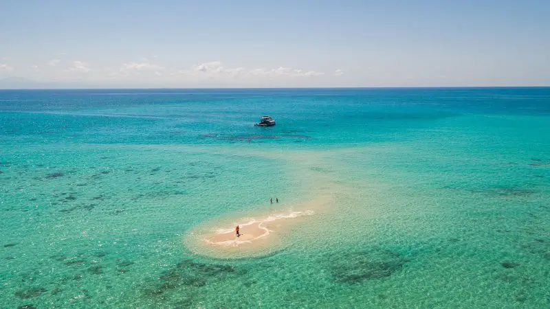 Small island with white sand in the ocean at Great Barrier Reef