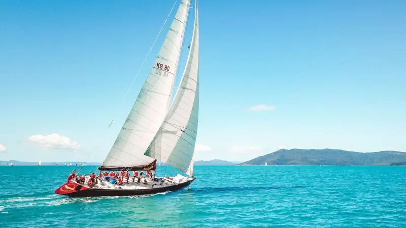Experience the ultimate 2 Day, 2 Night Condor Whitsunday Sailing adventure gliding over turquoise waters beneath clear skies and scenic hills.