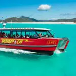 Experience the Thundercat 1 Day Whitsunday Islands Adventure gliding on turquoise waters by pristine white sands and lush green hills.