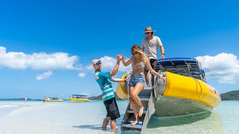 people getting of ocean rafting boat