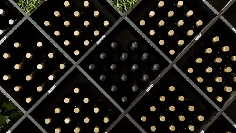 Rows of premium wine bottles with elegant gold and black caps, ready for exclusive gourmet tasting events on the Gold Coast.