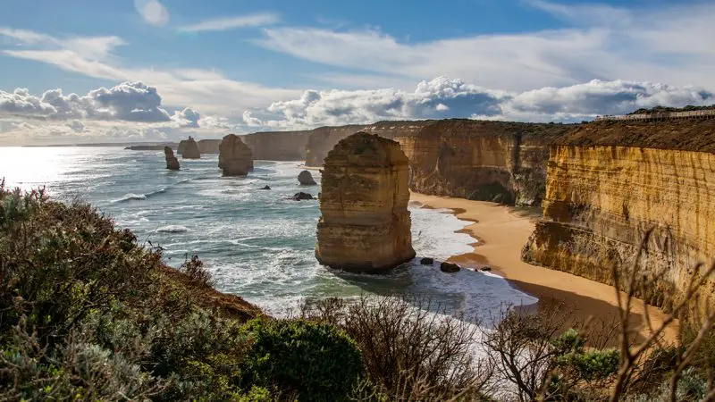 Iconic rock formations tower above the crashing waves on the scenic 2 Day Great Ocean Road Melbourne to Adelaide Overland Journey.