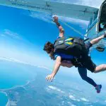 Experience an exhilarating Mission Beach tandem skydive up to 15,000ft over breathtaking coastline, clear blue sky, and ocean views.