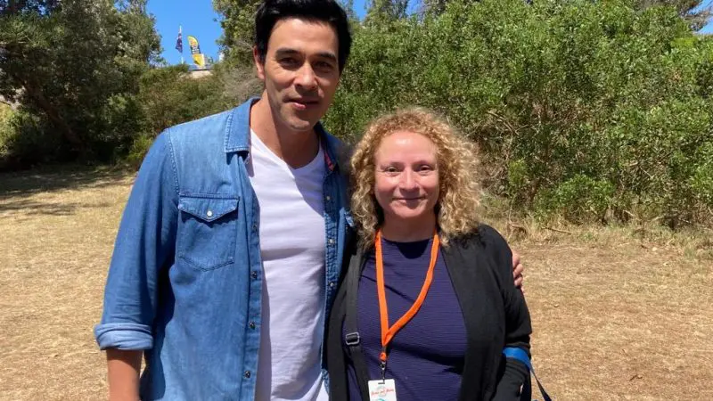 Smiling man in a blue shirt and woman with curly hair enjoying an outdoor Celebtime Tours adventure experience under sunny skies.