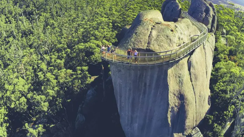 Stunning aerial view of tourists walking a curved walkway over granite rocks on the 6 Day Esperance Margaret River Adventure Tour.