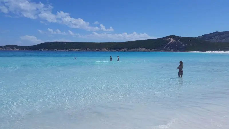 Visitors enjoying swimming in pristine turquoise waters on Esperance Beach during the 6 Day Esperance Margaret River Adventure Tour.