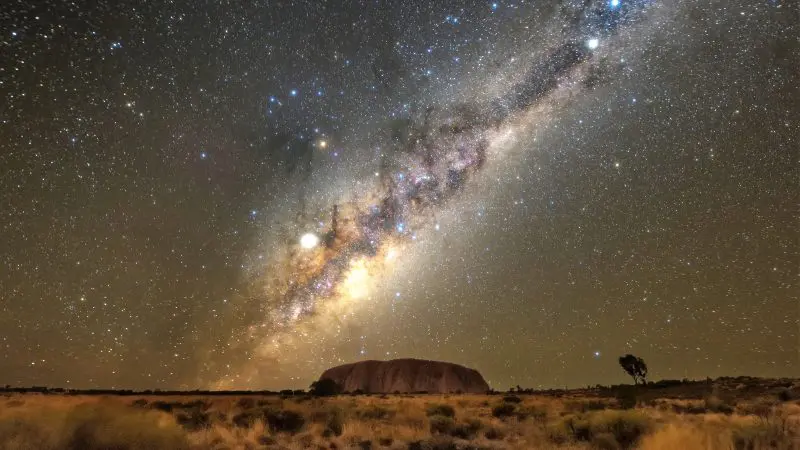 Stunning Milky Way illuminates Uluru at night on a 2 Day Uluru Kata Tjuta Rock Tour departing from Ayers Rock Yulara.