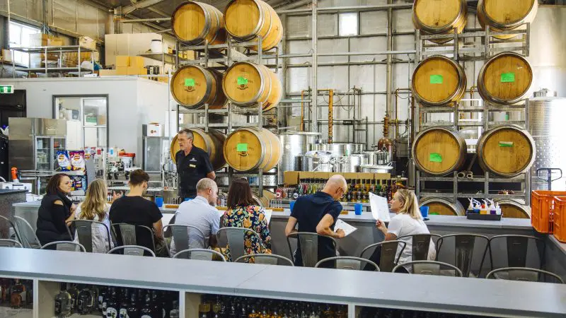 Guests savour craft beverages at a lively brewery bar, capturing the premium Hunter Valley Signature Wine Tour atmosphere and experience.