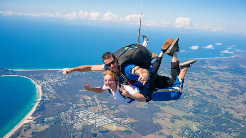 Experience the thrill of tandem skydiving above Byron Bay at 15,000ft, with ocean views and Brisbane transfer included.