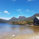 Scenic rustic boathouse on crystal-clear lake at Cradle Mountain, featured on a top-rated 2-Day Hobart tour with Wild Tasmania Tours.