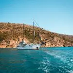 Experience the iconic white sailboat gliding on vibrant blue waters during the Fully Guided Ultimate East Coast Sydney to Cairns tour.
