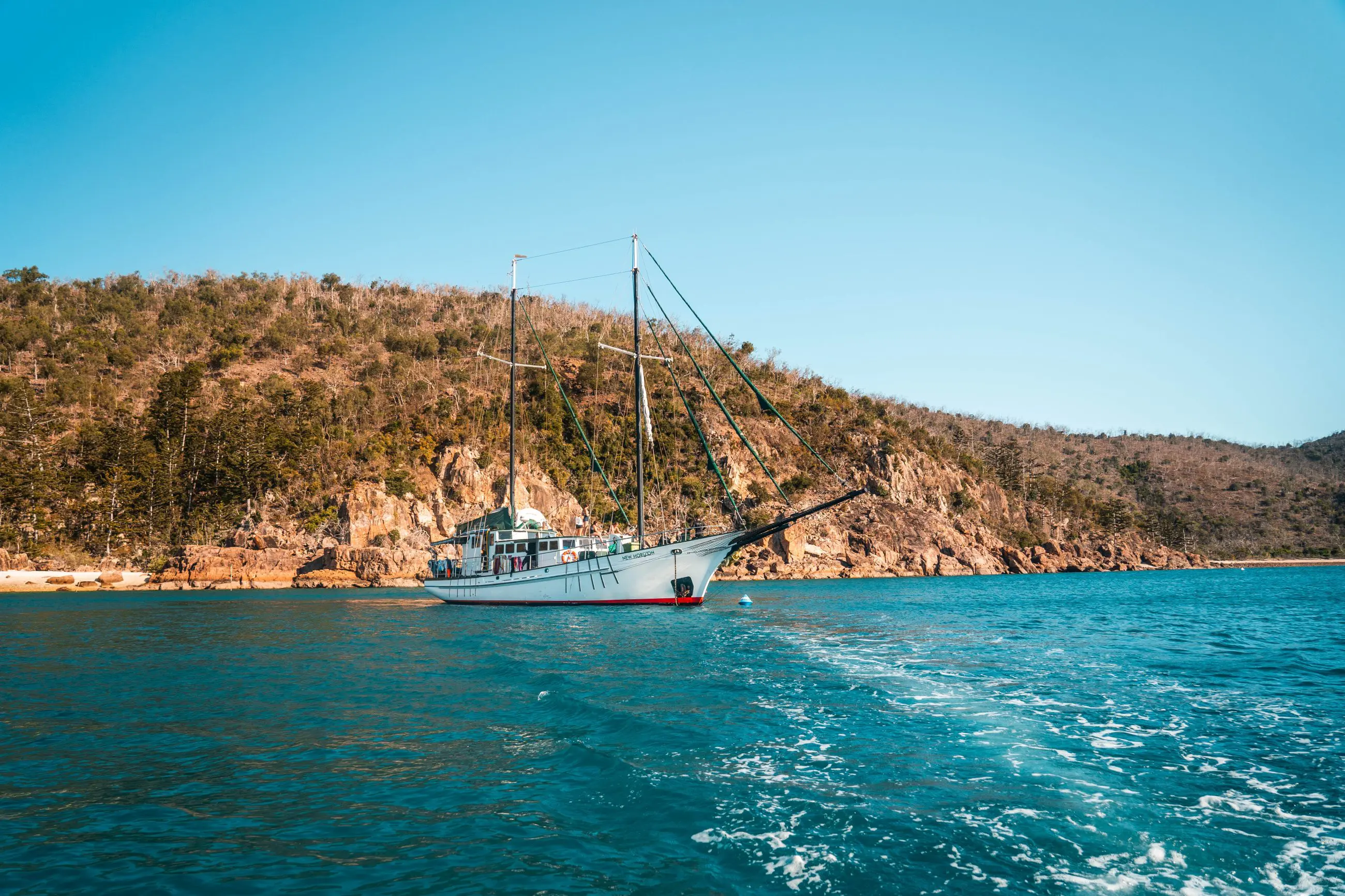Experience the iconic white sailboat gliding on vibrant blue waters during the Fully Guided Ultimate East Coast Sydney to Cairns tour.
