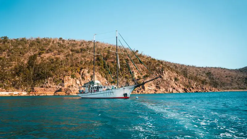 Experience the iconic white sailboat gliding on vibrant blue waters during the Fully Guided Ultimate East Coast Sydney to Cairns tour.