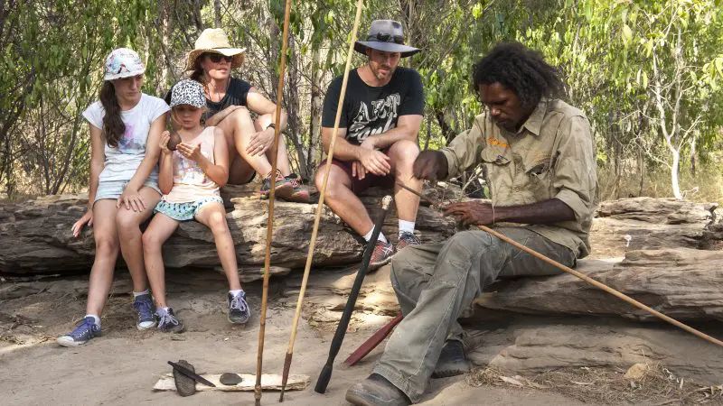 Expert guide showcases authentic traditional tools to a family on a 4 Day Kakadu Katherine Gorge tour departing from Darwin.