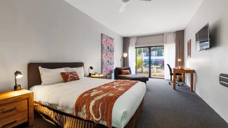 Spacious modern hotel room with private balcony overlooking scenic views, ideal accommodation for 4 Day Kakadu Katherine Gorge Tour.