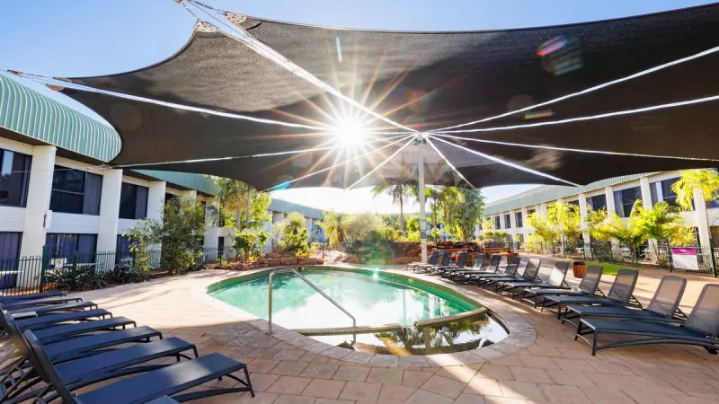 Scenic outdoor pool with plush loungers, ideal for unwinding after a 4 Day Kakadu Katherine Gorge tour from Darwin.