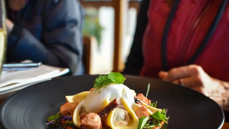 Elegant gourmet pasta dish garnished with fresh greens and a perfectly poached egg, ideal après Coal River Valley Wine & Gin Safari.