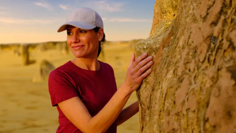 Woman in red shirt hikes among Pinnacles desert rock formations on a guided 1 Day Sunset Stargazing Tour with Autopia travel.