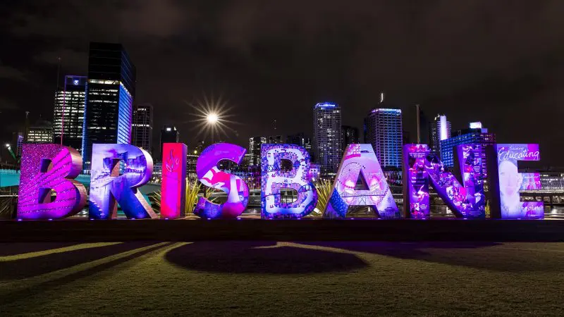Vibrant, illuminated BRISBANE sign at night—top photo hotspot during The Great Escape Australia 28 Day Semi-Guided tour experience.