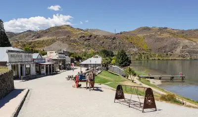 Discover a picturesque lakeside historic village featuring charming western-style buildings, mountain views, and a boutique wine tour.