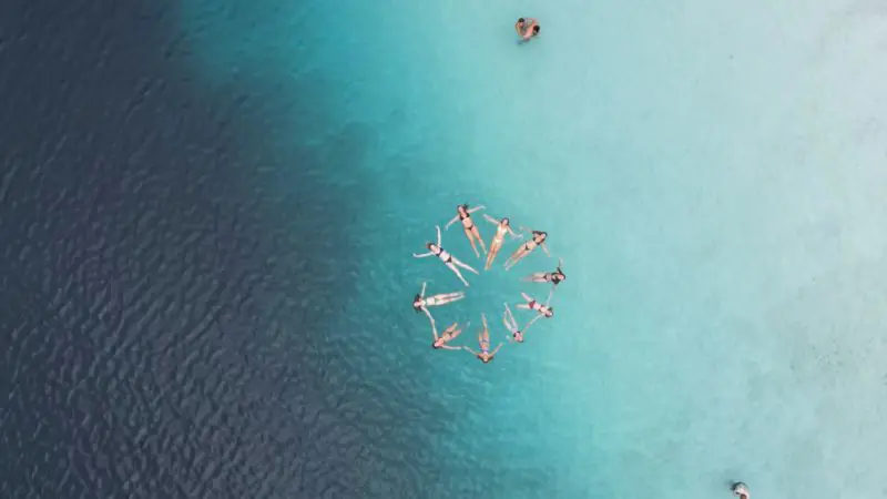 Stunning aerial shot of swimmers enjoying crystal-clear blue waters, capturing the essence of a Kgari 2 Day Tour Noosa-to-Noosa adventure.