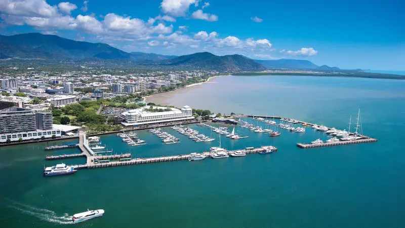 Stunning aerial view of marina with boats and city skyline on 14 Day Sydney to Cairns, Fraser Island & Whitsundays Comfort Tour.