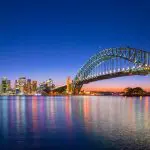 Sydney Harbour Bridge at dusk with shimmering city lights—your gateway to the ultimate 8 Day Sydney to Brisbane Fraser Island tour.