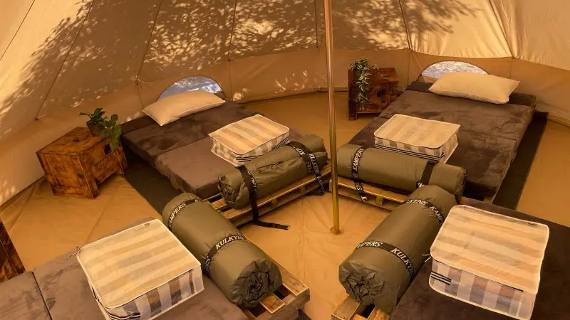 Inside a spacious canvas tent on Kangaroo Island, four camp beds with cosy sleeping bags and pillows await on a 2-day adventure.