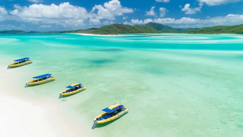 whitsundays beach with three boats