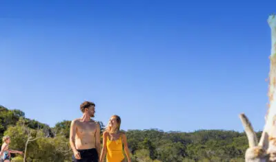 Twop backpackers exploring K'gari at Lake Mckenzie with Peterpans