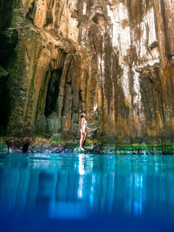 Woman standing in the Sawa I Lau Caves in the Blue lagoon region in fiji