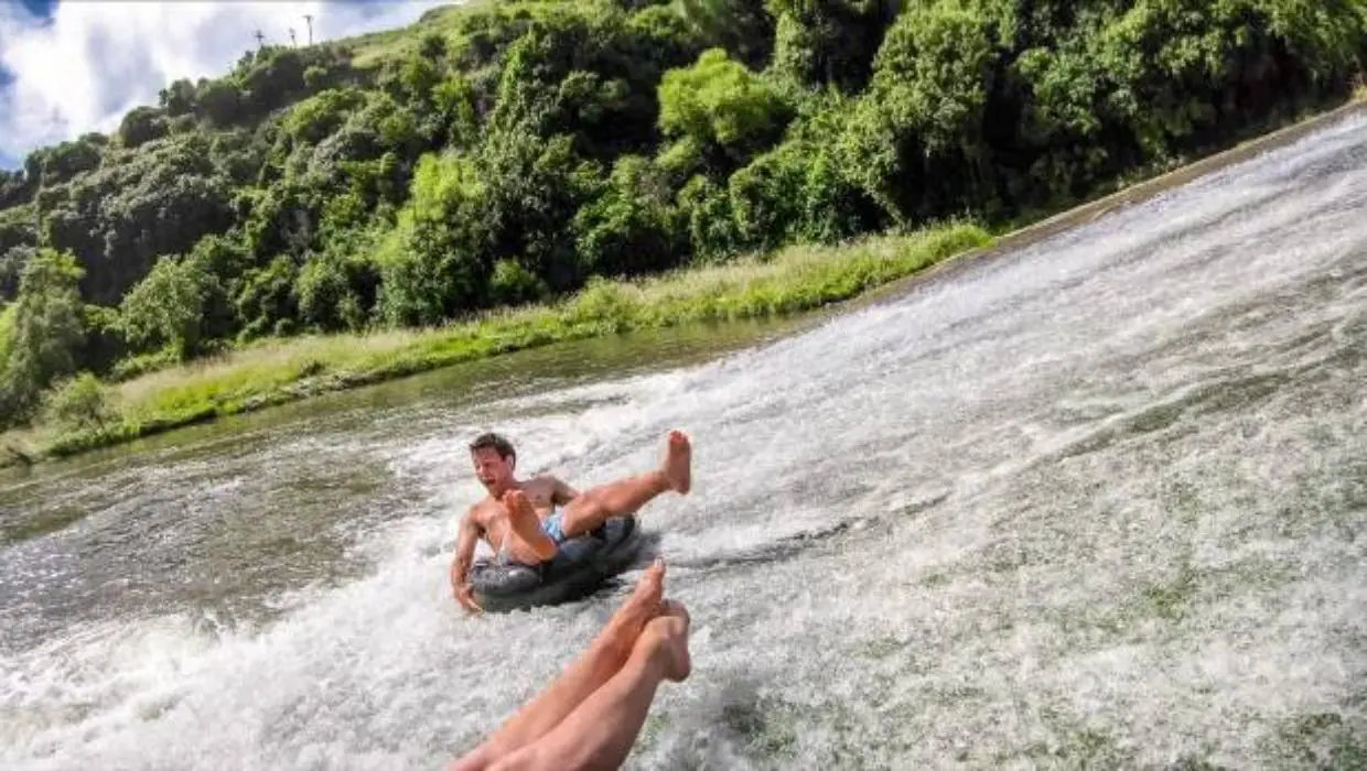 Man in tube going down a rock waterslide